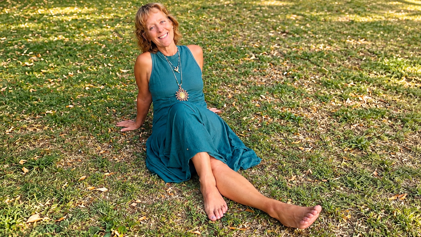 Claudia Fornito sitzt lächelnd im Gras
